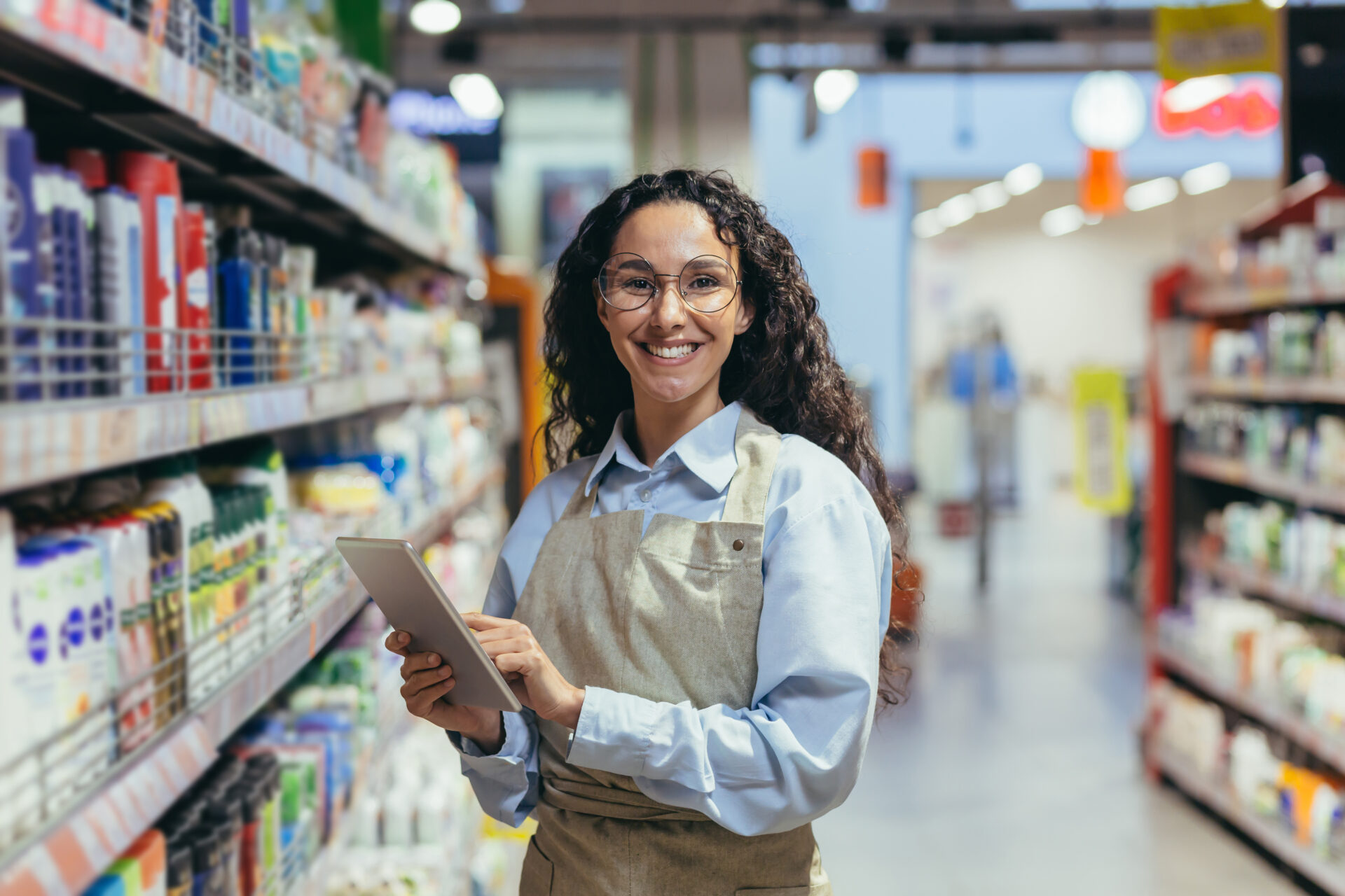 portrait-happy-successful-saleswoman hispanic woman with curly hair smiling looking